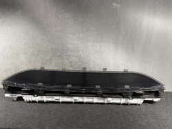 Curved black automotive instrument cluster housing with mounting clips and light-gray connector base