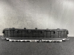 Long black automotive grille/vent piece with multiple mounting clips and a grey underside edge.