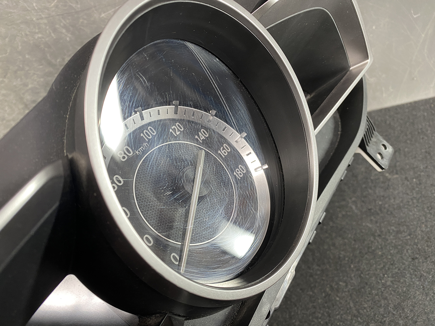 B478_9 MAZDA DEMIO CX-3 Genuine Instrument Cluster K1054 / D09M 55 430 » NZ1.95 » JDM-PARTS NZ » JDM-PARTS NZ Close-up of a car speedometer displaying km/h, with the needle near 0. MAZDA DEMIO CX-3 Genuine Instrument Cluster K1054 / D09M 55 430 » JDM-PARTS NZ
