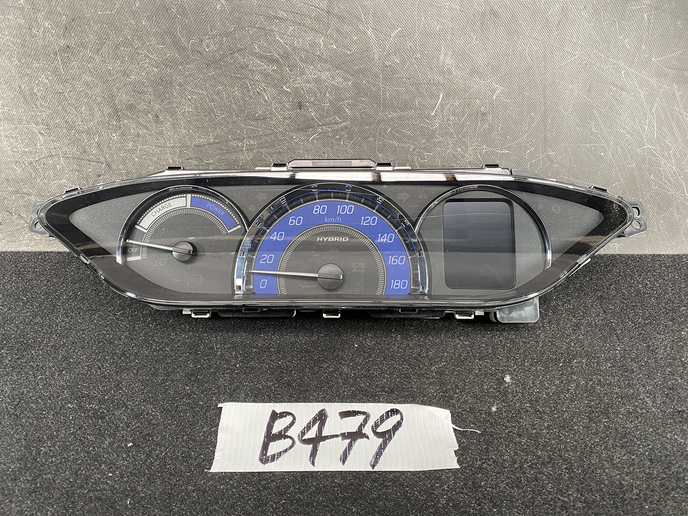 B479_2 SUZUKI SOLIO MITSUBISHI DELICA D2 Instrument Cluster 34111-81PS0 / 34104-81PA » NZ1.95 » JDM-PARTS NZ » JDM-PARTS NZ Hybrid car instrument cluster with blue arc speedometer (0–180 km/h), left charge/power gauge, and a right digital display area. SUZUKI SOLIO MITSUBISHI DELICA D2 Instrument Cluster 34111-81PS0 / 34104-81PA » JDM-PARTS NZ