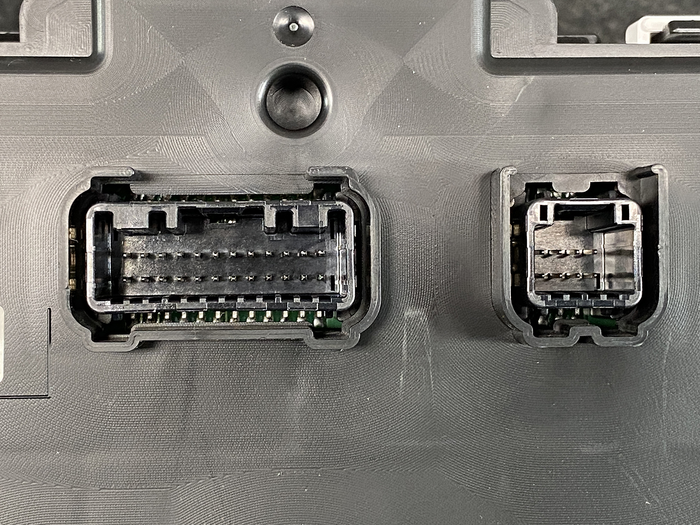 B479_4 SUZUKI SOLIO MITSUBISHI DELICA D2 Instrument Cluster 34111-81PS0 / 34104-81PA » NZ1.95 » JDM-PARTS NZ » JDM-PARTS NZ Close-up of two automotive-style connectors on a dark panel: a wide multi-pin plug on the left and a smaller one on the right. SUZUKI SOLIO MITSUBISHI DELICA D2 Instrument Cluster 34111-81PS0 / 34104-81PA » JDM-PARTS NZ