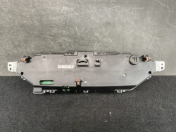Rear view of a car instrument cluster module with multiple connectors and mounting tabs