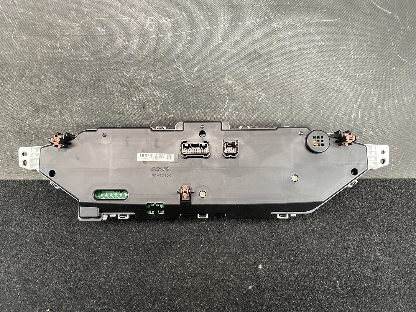 B479_5 SUZUKI SOLIO MITSUBISHI DELICA D2 Instrument Cluster 34111-81PS0 / 34104-81PA » NZ1.95 » JDM-PARTS NZ » JDM-PARTS NZ Rear view of a car instrument cluster module with multiple connectors and mounting tabs SUZUKI SOLIO MITSUBISHI DELICA D2 Instrument Cluster 34111-81PS0 / 34104-81PA » JDM-PARTS NZ