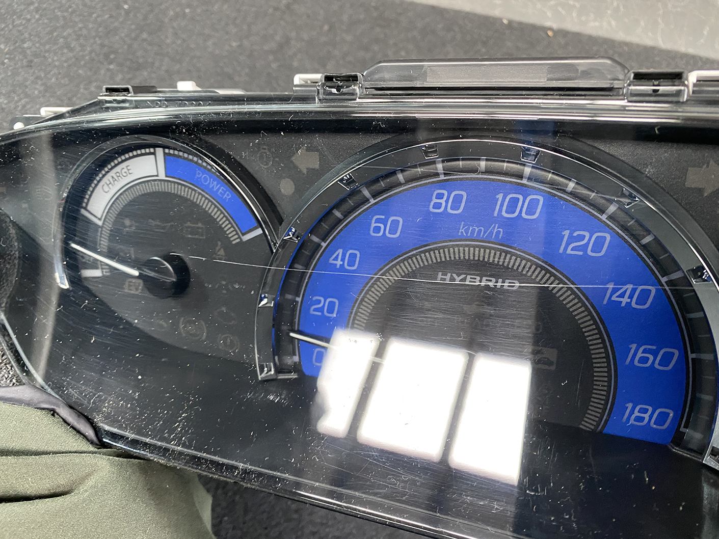 B479_9 SUZUKI SOLIO MITSUBISHI DELICA D2 Instrument Cluster 34111-81PS0 / 34104-81PA » NZ1.95 » JDM-PARTS NZ » JDM-PARTS NZ Hybrid car dashboard: blue 0–180 km/h speedometer with a left charge/power gauge and reflective glass glare SUZUKI SOLIO MITSUBISHI DELICA D2 Instrument Cluster 34111-81PS0 / 34104-81PA » JDM-PARTS NZ