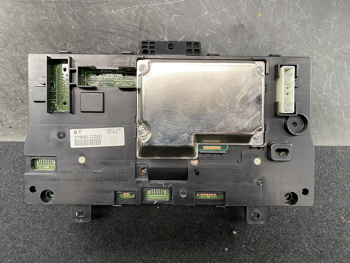 B480_5 NISSAN NV350 CARAVAN E26 Genuine Instrument Cluster 3YB0D TYPE: 883B » NZ1.95 » JDM-PARTS NZ » JDM-PARTS NZ Vehicle ECU with metal shielding and a white multi-pin connector on the right side NISSAN NV350 CARAVAN E26 Genuine Instrument Cluster 3YB0D TYPE: 883B » JDM-PARTS NZ
