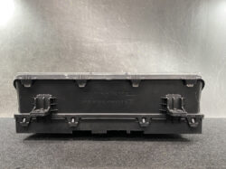 Black plastic electrical ECU-style module with a clear snap-on lid and multiple side latches, viewed from the back.