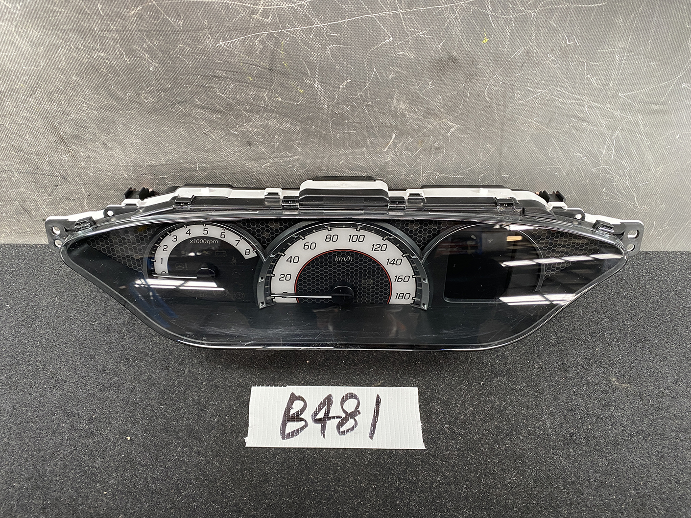 B481_2 SUZUKI SOLIO MITSUBISHI DELICA D2 Instrument Cluster 34110-81PN0 / 34102-81PA » NZ1.95 » JDM-PARTS NZ » JDM-PARTS NZ Car instrument cluster showing tachometer (0–8 x1000 rpm) and speedometer (0–180 km/h) in a black bezel. SUZUKI SOLIO MITSUBISHI DELICA D2 Instrument Cluster 34110-81PN0 / 34102-81PA » JDM-PARTS NZ