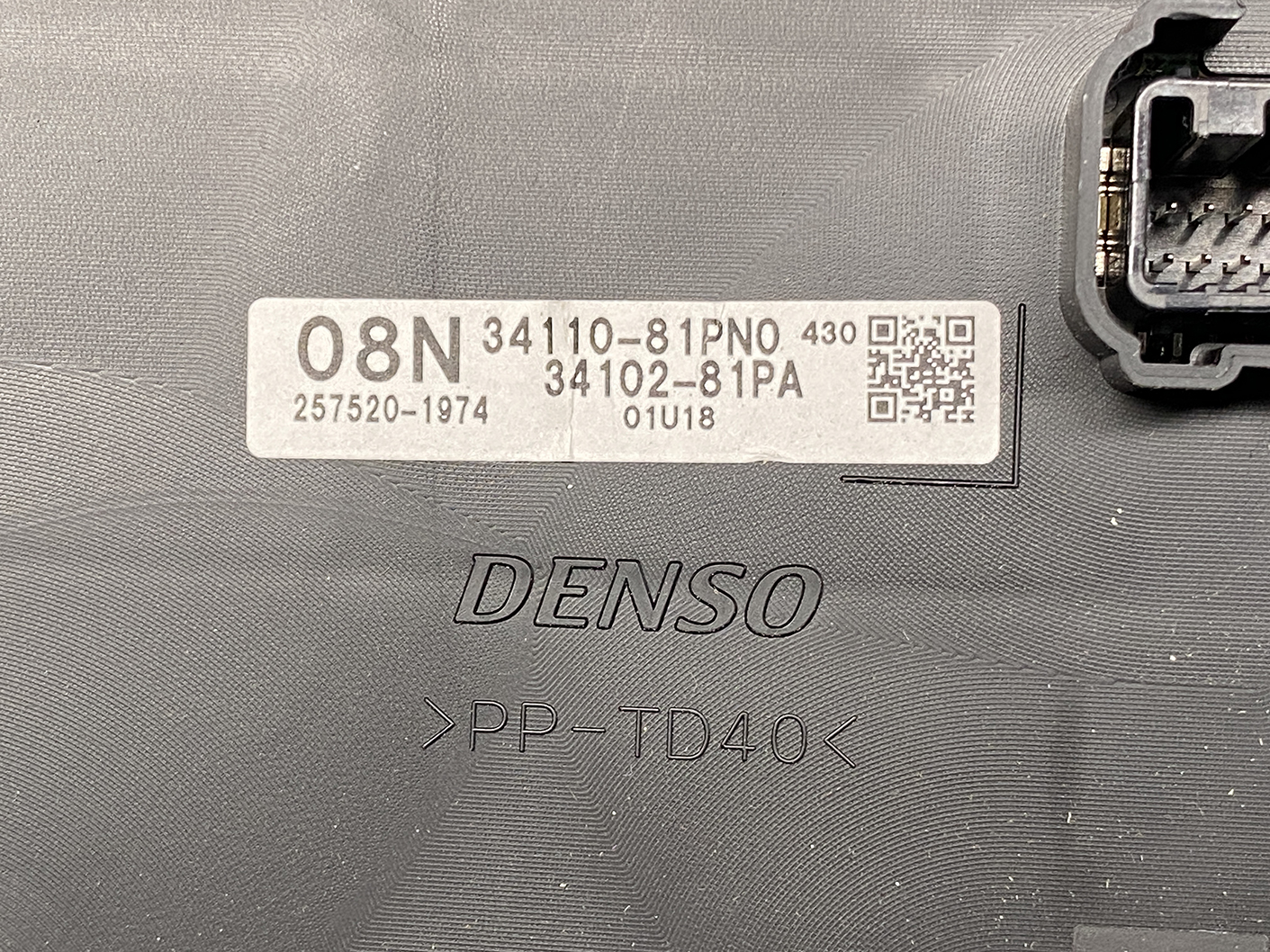 B481_3 SUZUKI SOLIO MITSUBISHI DELICA D2 Instrument Cluster 34110-81PN0 / 34102-81PA » NZ1.95 » JDM-PARTS NZ » JDM-PARTS NZ Close-up of a DENSO automotive control module label showing part numbers 34110-81P0 and 34102-81PA, 08N, a QR code, and serial 01U18 on a textured surface. SUZUKI SOLIO MITSUBISHI DELICA D2 Instrument Cluster 34110-81PN0 / 34102-81PA » JDM-PARTS NZ