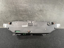 Rear view of a Denso instrument cluster module with multiple connectors and mounting lugs
