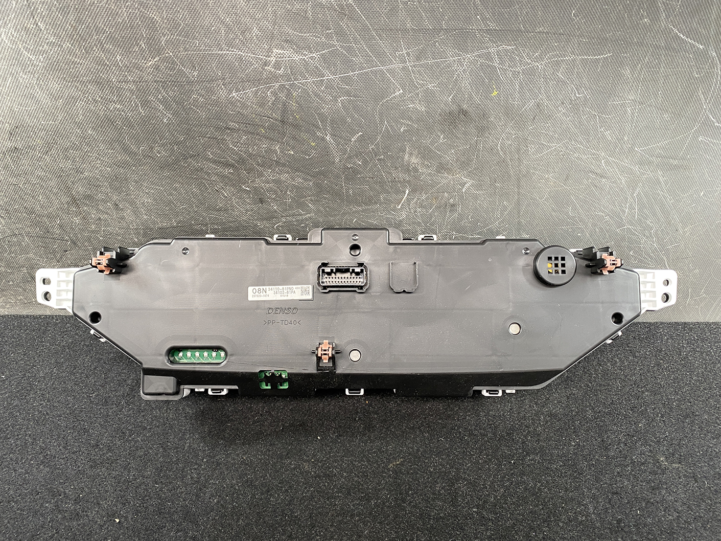 B481_5 SUZUKI SOLIO MITSUBISHI DELICA D2 Instrument Cluster 34110-81PN0 / 34102-81PA » NZ1.95 » JDM-PARTS NZ » JDM-PARTS NZ Rear view of a Denso instrument cluster module with multiple connectors and mounting lugs SUZUKI SOLIO MITSUBISHI DELICA D2 Instrument Cluster 34110-81PN0 / 34102-81PA » JDM-PARTS NZ