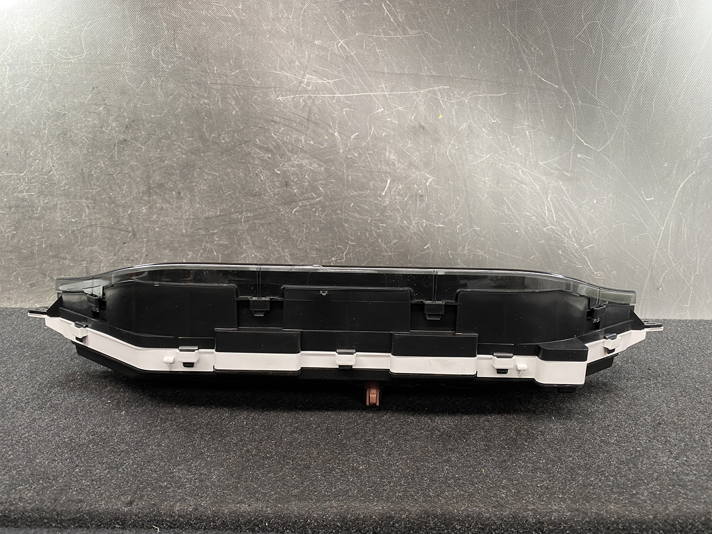 B481_7 SUZUKI SOLIO MITSUBISHI DELICA D2 Instrument Cluster 34110-81PN0 / 34102-81PA » NZ1.95 » JDM-PARTS NZ » JDM-PARTS NZ Automotive instrument cluster housing with clear cover, black plastic, mounted on a work surface. SUZUKI SOLIO MITSUBISHI DELICA D2 Instrument Cluster 34110-81PN0 / 34102-81PA » JDM-PARTS NZ