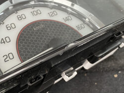 Close-up of a car speedometer up to 160 km/h with a cracked display cover.