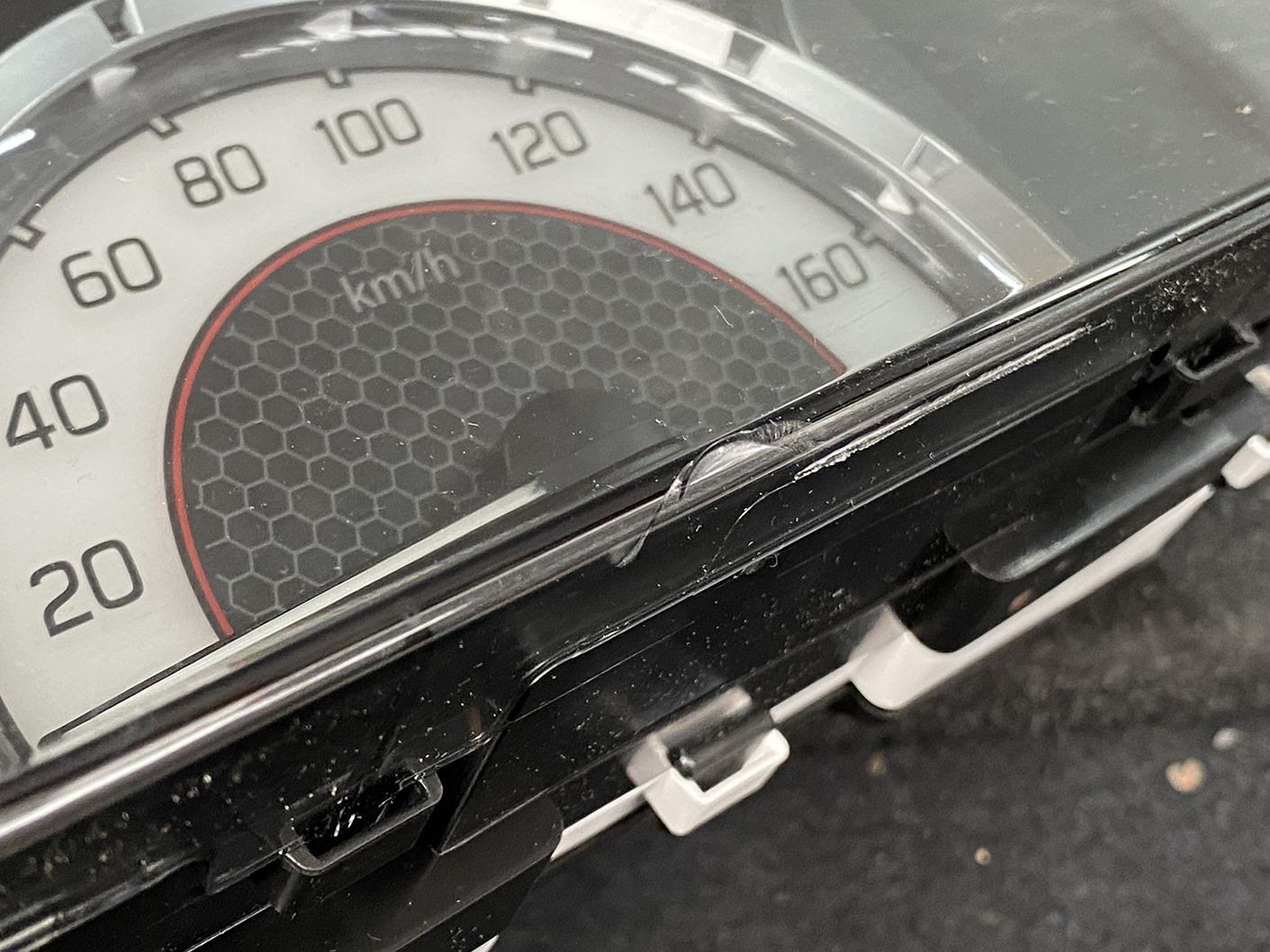 B481_8 SUZUKI SOLIO MITSUBISHI DELICA D2 Instrument Cluster 34110-81PN0 / 34102-81PA » NZ1.95 » JDM-PARTS NZ » JDM-PARTS NZ Close-up of a car speedometer up to 160 km/h with a cracked display cover. SUZUKI SOLIO MITSUBISHI DELICA D2 Instrument Cluster 34110-81PN0 / 34102-81PA » JDM-PARTS NZ