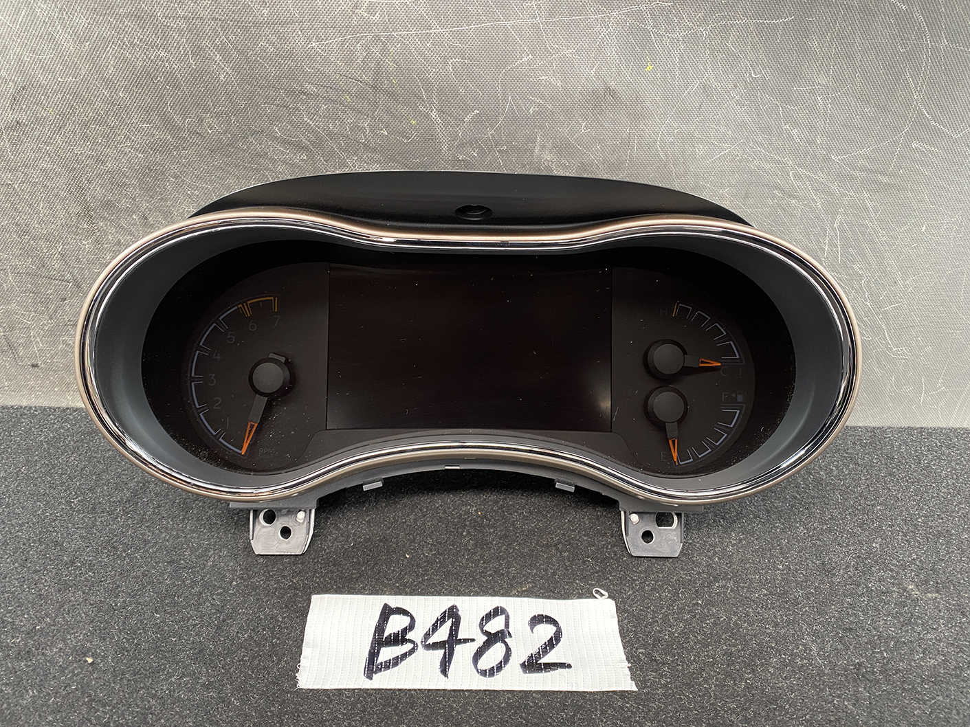 B482_2 Jeep Grand Cherokee WK57A Genuine Instrument Cluster 68235673AA » NZ1.95 » JDM-PARTS NZ » JDM-PARTS NZ Vehicle instrument cluster showing left tachometer and right speedometer with orange needles; central digital display. Jeep Grand Cherokee WK57A Genuine Instrument Cluster 68235673AA » JDM-PARTS NZ