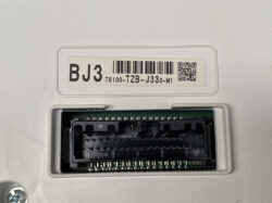 Back view of an electronic control unit with a large black multi-pin connector and a label reading BJ3 78100-TZB-J330-M1 (barcode and QR code).
