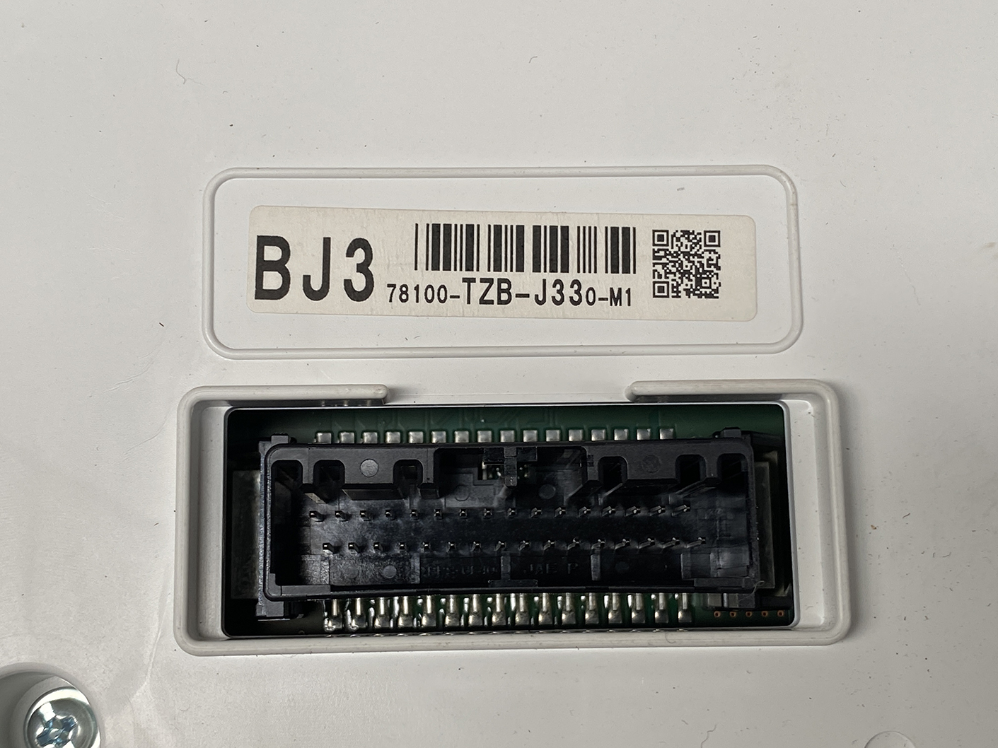 B483_3 HONDA FIT JAZZ GR6 Genuine Instrument Cluster BJ3 78100-TZB-J330-M1 » NZ1.95 » JDM-PARTS NZ » JDM-PARTS NZ Back view of an electronic control unit with a large black multi-pin connector and a label reading BJ3 78100-TZB-J330-M1 (barcode and QR code). HONDA FIT JAZZ GR6 Genuine Instrument Cluster BJ3 78100-TZB-J330-M1 » JDM-PARTS NZ