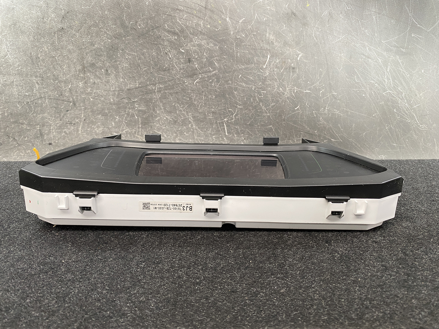 B483_6 HONDA FIT JAZZ GR6 Genuine Instrument Cluster BJ3 78100-TZB-J330-M1 » NZ1.95 » JDM-PARTS NZ » JDM-PARTS NZ Automotive digital instrument cluster with rectangular display in a white housing on a dark work surface. HONDA FIT JAZZ GR6 Genuine Instrument Cluster BJ3 78100-TZB-J330-M1 » JDM-PARTS NZ
