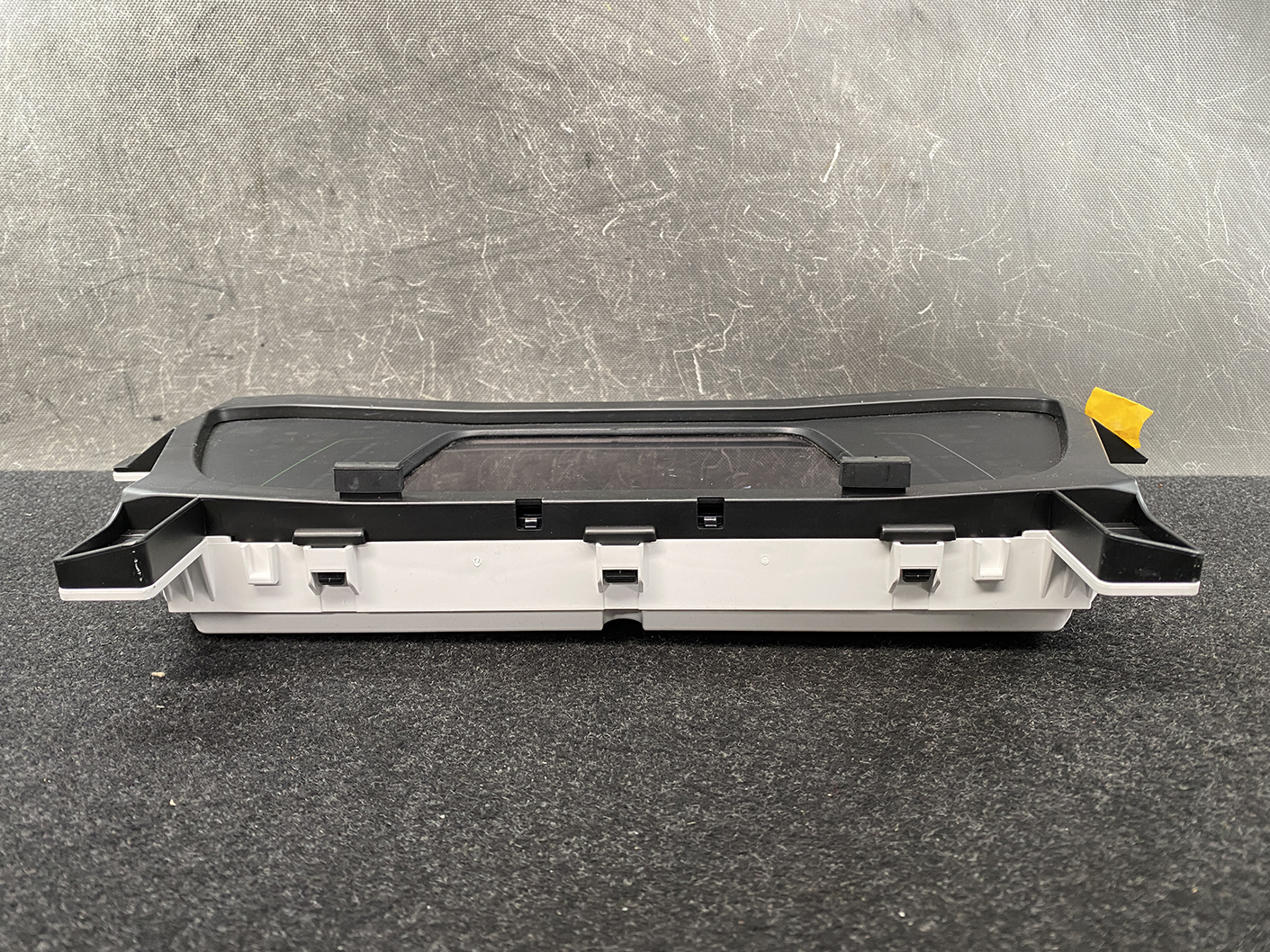 B483_7 HONDA FIT JAZZ GR6 Genuine Instrument Cluster BJ3 78100-TZB-J330-M1 » NZ1.95 » JDM-PARTS NZ » JDM-PARTS NZ Automotive dashboard control module (center console) with a black cover and gray housing on a dark surface. HONDA FIT JAZZ GR6 Genuine Instrument Cluster BJ3 78100-TZB-J330-M1 » JDM-PARTS NZ