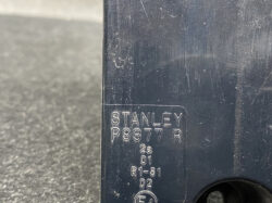 Close-up of a dark metal surface with an engraved label reading STANLEY P9377 R and small codes underneath (2a 01 R1-S1 02).