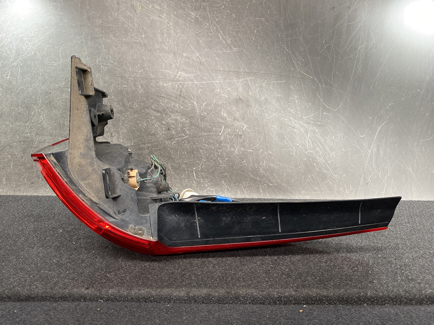 B485_5 MAZDA PREMACY CW NISSAN LAFESTA Taillight P9377 Right Side x1 » NZ1.95 » JDM-PARTS NZ » JDM-PARTS NZ Rear car taillight assembly with red lens and black housing, exposed mounting area and wiring harnesses show dirt buildup. MAZDA PREMACY CW NISSAN LAFESTA Taillight P9377 Right Side x1 » JDM-PARTS NZ