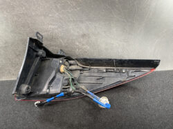 Left rear tail light assembly removed, exposing wiring harness and connector.