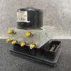 Automotive brake modulator with a metal valve block, yellow port caps, and a black base module. Toyota Dyna TOYOACE Genuine ABS Actuator Pump  44540-37110 / 133800-2120 » JDM-PARTS NZ