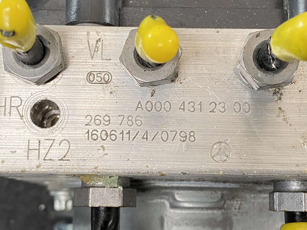 BNZ-ACTR-A000431 _4 Mercedes Benz Genuine ABS Actuator Pump A000 431 23 00 / 0 265 255 634 » NZ9.95 » JDM-PARTS NZ » JDM-PARTS NZ Close-up of a metal valve block with three yellow-tipped terminals and stamped part numbers (A000 431 23 00) and a Mercedes logo, indicating an automotive hydraulic/electrical component. Mercedes Benz Genuine ABS Actuator Pump A000 431 23 00 / 0 265 255 634 » JDM-PARTS NZ