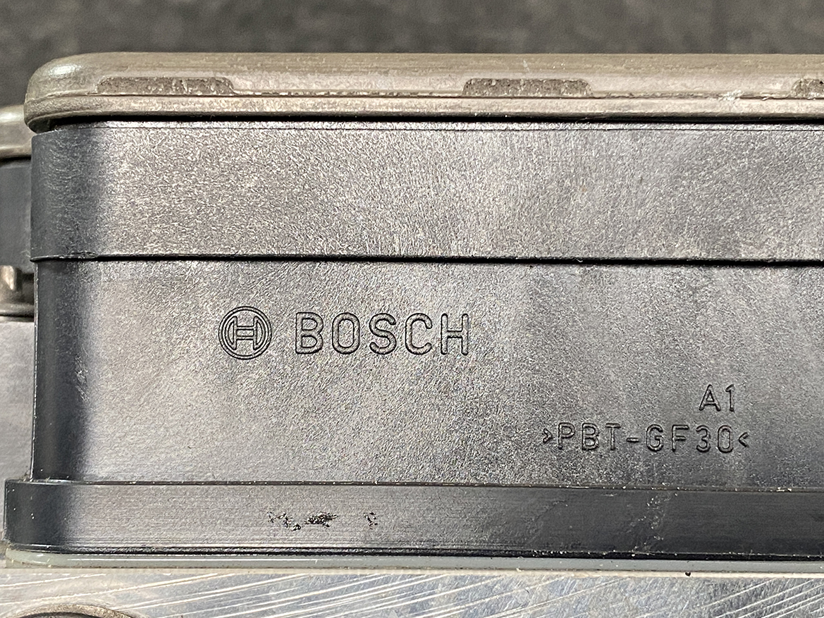 BNZ-ACTR-A000431 _6 Mercedes Benz Genuine ABS Actuator Pump A000 431 23 00 / 0 265 255 634 » NZ9.95 » JDM-PARTS NZ » JDM-PARTS NZ Close-up of a dusty Bosch plastic automotive module with logo and part code A1 >PBT-GF30 Mercedes Benz Genuine ABS Actuator Pump A000 431 23 00 / 0 265 255 634 » JDM-PARTS NZ