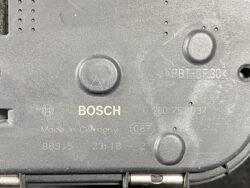 Back panel of a Bosch device showing the Bosch logo, 'Made in Germany' text, and various part numbers (0 280 750 137) with circular indentations and a triangle button grip nearby.