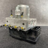 HON-ACTR-T5BJ0 _2 Subaru Levorg Genuine ABS Actuator Pump 27536VA010 » NZ9.95 » JDM-PARTS NZ » JDM-PARTS NZ Automotive ABS pump module with metal block and four brake line fittings connected to a black plastic base connector. Subaru Levorg Genuine ABS Actuator Pump 27536VA010 » JDM-PARTS NZ