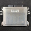 Automotive engine control unit (ECU) with a metal silver housing, mounting lugs on sides and a barcode label on top surface. Lexus LS600h UVF45 Genuine Engine ECU/ 89661-50E81 / 275500-1530 » JDM-PARTS NZ