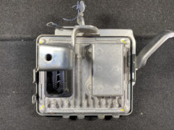 Automotive electronic control unit (ECU) housing with a multi-pin connector and mounting bracket, shown from above.