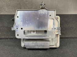 Automotive airbag control module: metal enclosure with mounting brackets and a visible label.