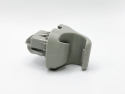 Gray plastic electrical connector housing with multiple pin terminals on a white background, shown from the side.