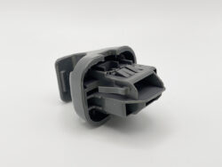 Gray plastic automotive-style electrical connector with interlocking latch tabs (close-up)
