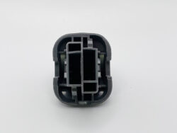 Close-up of a gray plastic connector housing with interlocking rectangular slots and internal channels (mechanical component)