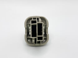 Beige plastic electrical connector housing with four rectangular cavities seen from the front, stacked in two columns inside a rounded shell