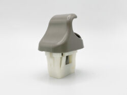 Gray rocker-style plastic switch mounted on a white plastic base (electrical component)
