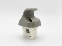 Small gray plastic lever clipped onto a white plastic connector, likely a mechanical actuator or switch housing