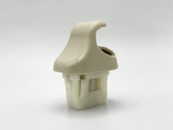 Beige plastic clip-on fastener with curved top and hollow base.