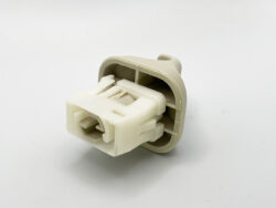 White plastic electrical connector housing with multiple pin slots (no wires)