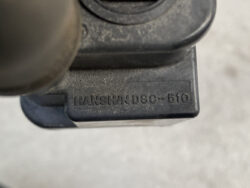 Close-up of a black plastic component with a raised model/serial code reading HANSWNDSC-510, dust present.