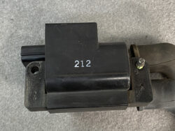 Black plastic electrical connector housing with the number 212 stamped on it, mounted to a metal bracket.