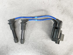 Ignition coil pack with two spark plug wires and a connector