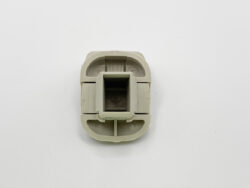 Light gray plastic connector piece with a hollow square center, viewed from above.