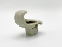 Beige plastic clip with a curved arm and rectangular base on a white background, isolated.