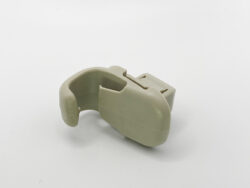 Beige plastic curved clamp-like component with a rectangular connector, shown on a white background.