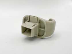 Beige plastic electrical connector clip with a rectangular socket and locking tab, shown on a white background.