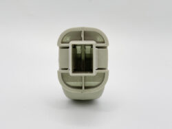 Close-up of a gray plastic electrical connector with a square central receptacle and internal pins.