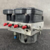 NIS-ACTR-4CA7A _2 Toyota Chaser Altezza Genuine ABS Actuator Pump 44510-24060 / 133000-5050 » NZ9.95 » JDM-PARTS NZ » JDM-PARTS NZ Bosch automotive ABS pump module with a metal valve block, red port caps, and a black control unit on top. Toyota Chaser Altezza Genuine ABS Actuator Pump 44510-24060 / 133000-5050 » JDM-PARTS NZ